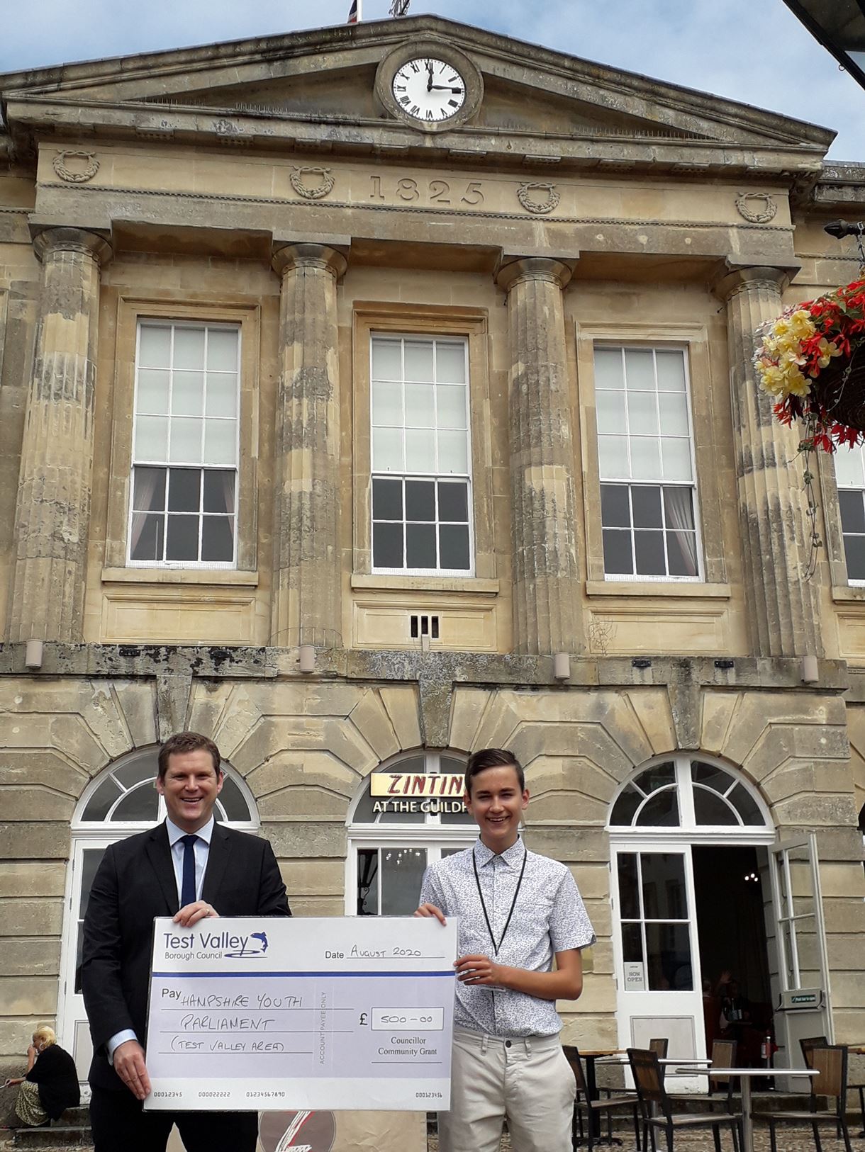 Picture caption: Councillor North presents the cheque to MYP Dmitrijs Meiksans in front of the Guildhall, Andover.